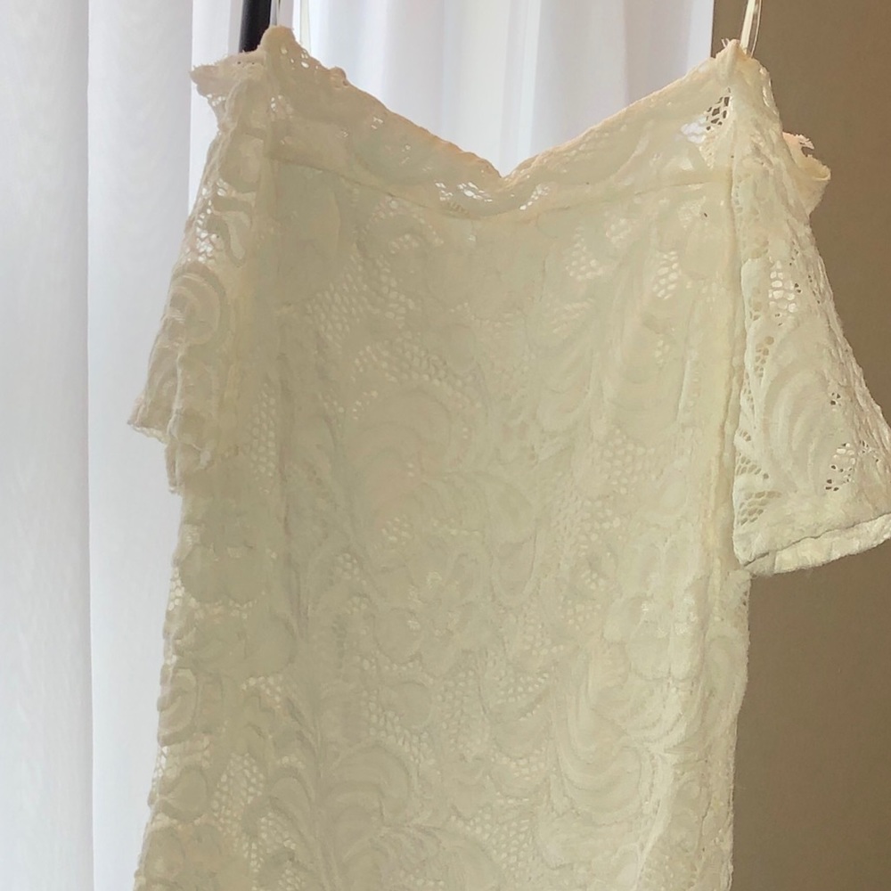Off the shoulder, white laced dress.